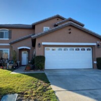 Picture taken outside beautiful home with light brown exterior painting