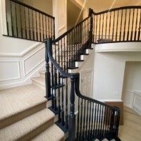 Staircase inside home with black railing