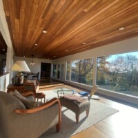 Sunroom at residential home with a chair and small table